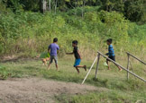 Peruvian Amazon Region, boys everywhere play with dogs.