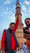 Delhi: Qutub Minar, Couple of guys playing with photography.