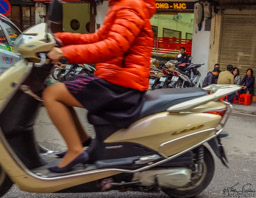 On her way to work, probably, on the scooter with heels.