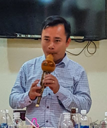 Final dinner, and final photo.  An, our guide, revealing to us yet one more talent.  Goodbye Vietnam.