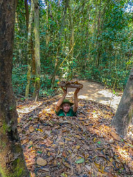 3 of 4:  He sinks into the tunnel, which is VERY narrow, holding the lid over his head.