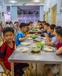 Dinner.  All of the children seem to be healthy, well-behaved, and enjoying each other.