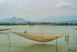 Fishing nets hanging over the water.  My understanding is that the nets will be lowered into the water, then later lifted by the 4 corners, and the catch harvested.