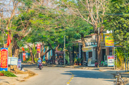 Typical street and shops from near Hoi An.  These shops look a bit more upscale than those in open bay doors.  i think the red signs are government propaganda.