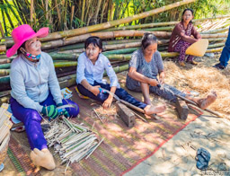 On a walk now, and came to these women making chopsticks form bamboo.