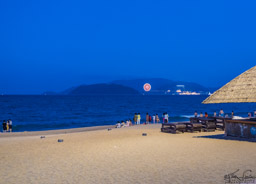 Dinner outside on the beach at Ngh Trang.  The target-looking thing is a ferris wheel at the amusement park.