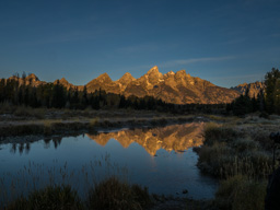Mountain fully illuminated now but not the golden trees at its base.