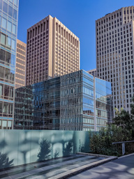 Shorter building takes on many odd reflections.